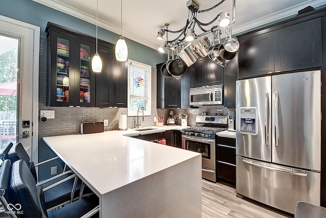 1551 N Park Ave, Indianapolis, IN 46202 - kitchen featuring appliances with stainless steel finishes, ornamental molding, light countertops, and tasteful backsplash