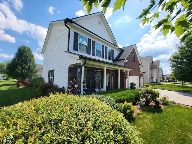 8433 Vyners Ln, Avon, IN 46123 - traditional home with a front yard, a garage, concrete driveway, brick siding, and a porch