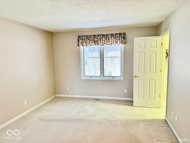3400 W Riggin Rd, Muncie, IN 47304 - carpeted spare room featuring a textured ceiling and baseboards