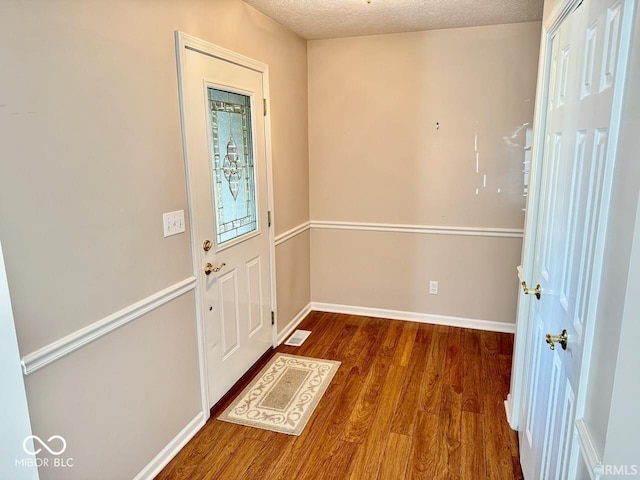 3400 W Riggin Rd, Muncie, IN 47304 - entryway featuring wood finished floors and a textured ceiling