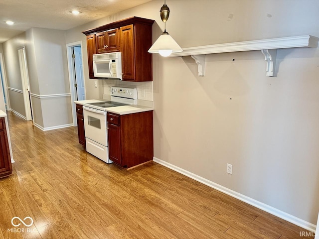 3400 W Riggin Rd, Muncie, IN 47304 - kitchen with white appliances, light wood-style flooring, light countertops, backsplash, and recessed lighting