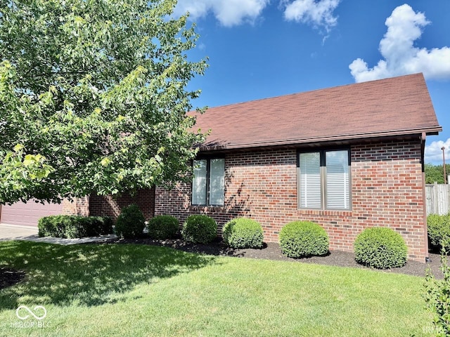 3400 W Riggin Rd, Muncie, IN 47304 - view of front facade featuring a front lawn, brick siding, and roof with shingles
