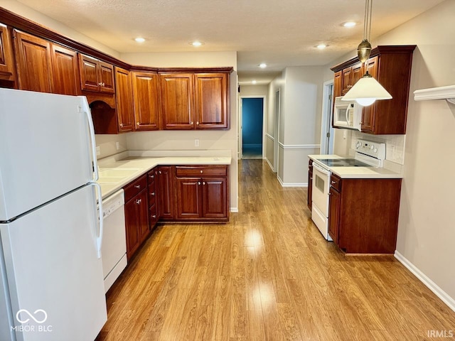 3400 W Riggin Rd, Muncie, IN 47304 - kitchen with white appliances, light wood-style flooring, light countertops, recessed lighting, and pendant lighting