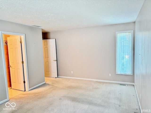 3400 W Riggin Rd, Muncie, IN 47304 - spare room with light colored carpet and a textured ceiling