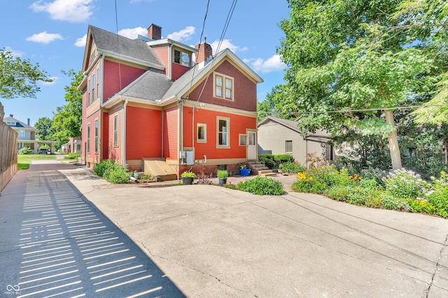 408 E Wabash Ave, Crawfordsville, IN 47933 - view of front of home featuring a chimney and roof with shingles