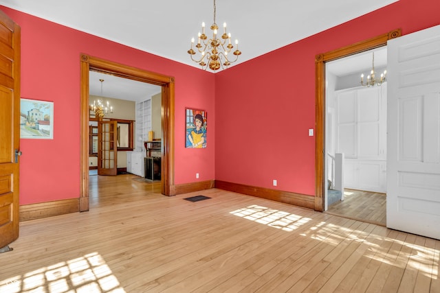 408 E Wabash Ave, Crawfordsville, IN 47933 - spare room with a chandelier and light wood-style floors