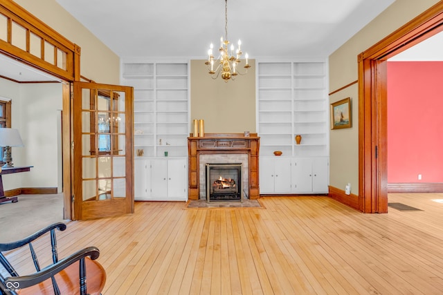 408 E Wabash Ave, Crawfordsville, IN 47933 - living area with built in shelves, a fireplace, a chandelier, and wood-type flooring