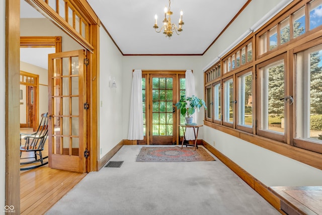 408 E Wabash Ave, Crawfordsville, IN 47933 - carpeted foyer featuring a chandelier, plenty of natural light, and ornamental molding