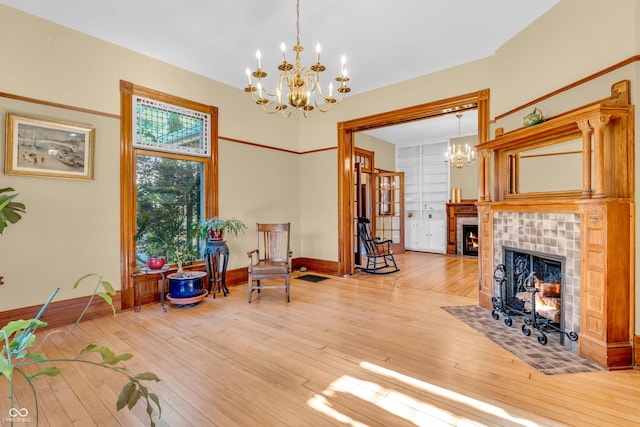 408 E Wabash Ave, Crawfordsville, IN 47933 - sitting room with a chandelier, a fireplace, and light wood-style flooring