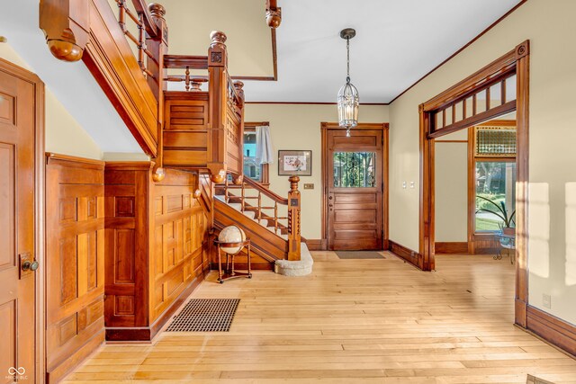 408 E Wabash Ave, Crawfordsville, IN 47933 - entrance foyer featuring stairs, light wood-type flooring, and ornamental molding