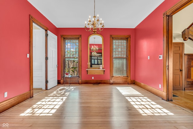 408 E Wabash Ave, Crawfordsville, IN 47933 - unfurnished dining area with a chandelier and wood-type flooring