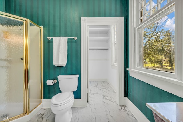 408 E Wabash Ave, Crawfordsville, IN 47933 - bathroom featuring marble look tile flooring, a stall shower, plenty of natural light, and a walk in closet