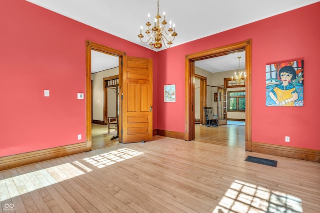 408 E Wabash Ave, Crawfordsville, IN 47933 - empty room featuring a chandelier and light wood finished floors