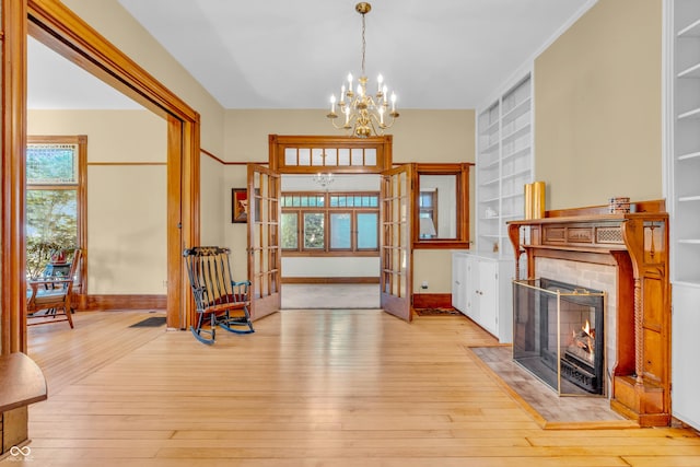 408 E Wabash Ave, Crawfordsville, IN 47933 - foyer entrance featuring a chandelier, french doors, hardwood / wood-style flooring, and a fireplace with flush hearth