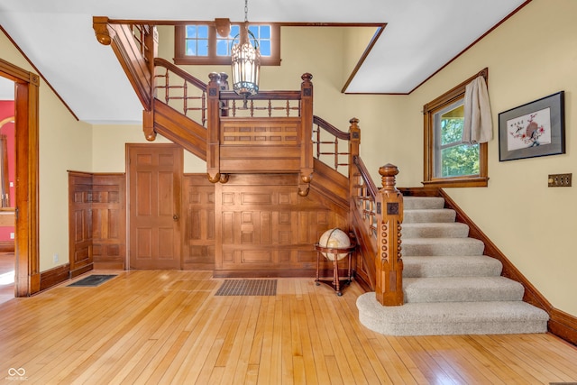 408 E Wabash Ave, Crawfordsville, IN 47933 - staircase with a chandelier, wood-type flooring, and crown molding