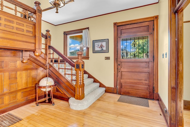 408 E Wabash Ave, Crawfordsville, IN 47933 - entrance foyer with stairway, plenty of natural light, hardwood / wood-style floors, and ornamental molding