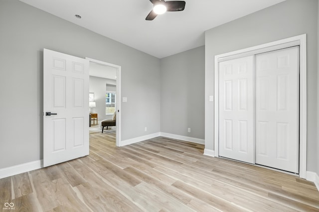 2012 N Dexter St, Indianapolis, IN 46202 - unfurnished bedroom with light wood-type flooring, a closet, and a ceiling fan