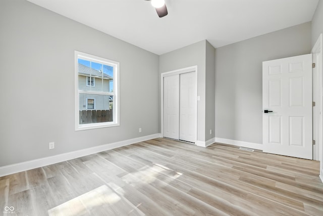 2012 N Dexter St, Indianapolis, IN 46202 - unfurnished bedroom featuring light wood-type flooring, a closet, and a ceiling fan
