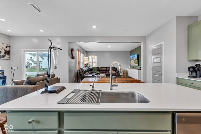 11480 Plough St, Noblesville, IN 46060 - kitchen with green cabinetry, open floor plan, light countertops, healthy amount of natural light, and recessed lighting
