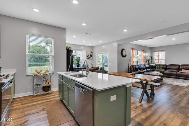 11480 Plough St, Noblesville, IN 46060 - kitchen with stainless steel appliances, open floor plan, green cabinets, wood finished floors, and light countertops