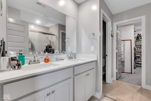 11480 Plough St, Noblesville, IN 46060 - bathroom with a stall shower, double vanity, tile patterned flooring, and a walk in closet