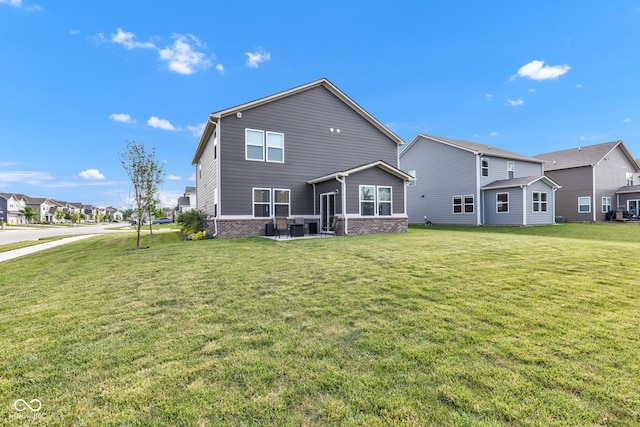 11480 Plough St, Noblesville, IN 46060 - back of property featuring a yard, brick siding, and a patio area