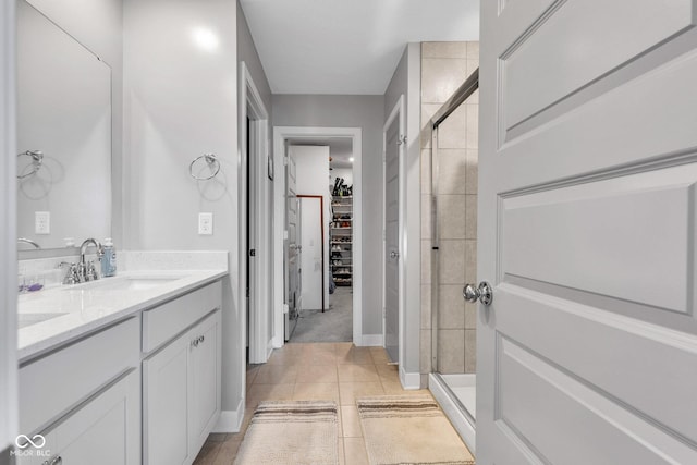 11480 Plough St, Noblesville, IN 46060 - bathroom with a walk in closet, a stall shower, double vanity, and tile patterned floors