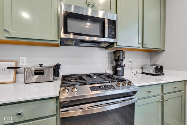 11480 Plough St, Noblesville, IN 46060 - kitchen featuring stainless steel appliances, green cabinetry, and light countertops