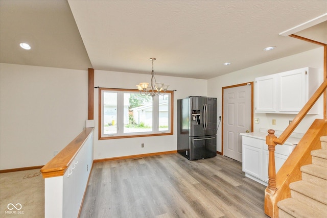 221 N Adams St, Brownsburg, IN 46112 - kitchen with refrigerator with ice dispenser, white cabinets, a chandelier, light wood-style floors, and recessed lighting