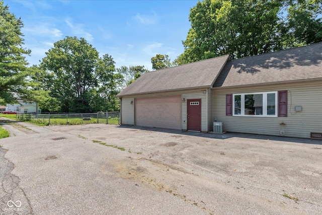 221 N Adams St, Brownsburg, IN 46112 - view of front facade featuring driveway, a garage, and roof with shingles