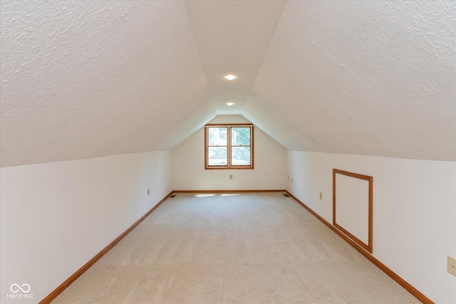 221 N Adams St, Brownsburg, IN 46112 - additional living space featuring a textured ceiling, lofted ceiling, light colored carpet, and recessed lighting
