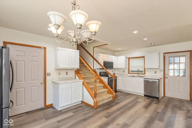221 N Adams St, Brownsburg, IN 46112 - kitchen featuring black appliances, dark wood-style flooring, white cabinetry, light countertops, and recessed lighting