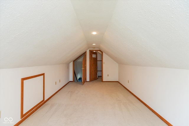 221 N Adams St, Brownsburg, IN 46112 - additional living space featuring vaulted ceiling, light colored carpet, a textured ceiling, and recessed lighting