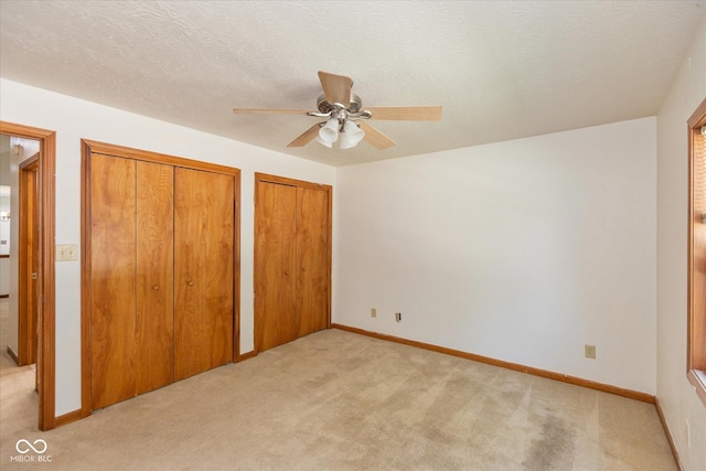 221 N Adams St, Brownsburg, IN 46112 - unfurnished bedroom with light colored carpet, two closets, and a ceiling fan