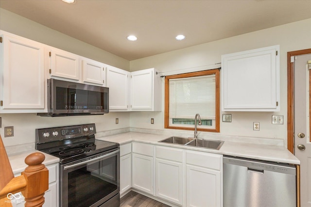 221 N Adams St, Brownsburg, IN 46112 - kitchen with appliances with stainless steel finishes, white cabinets, light countertops, recessed lighting, and wood finished floors