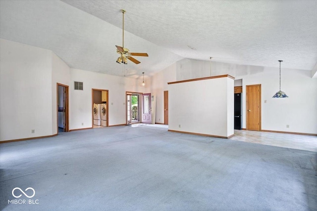 3628 Paddington Cir, Indianapolis, IN 46268 - unfurnished living room with independent washer and dryer, a ceiling fan, light colored carpet, high vaulted ceiling, and a textured ceiling