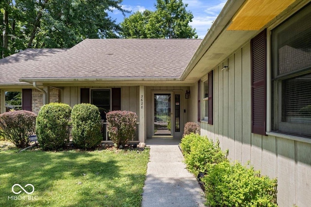 3628 Paddington Cir, Indianapolis, IN 46268 - view of exterior entry with roof with shingles and a lawn