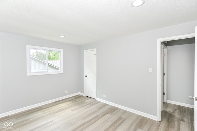 2521 Winfield Ave, Indianapolis, IN 46222 - empty room with light wood-style flooring, recessed lighting, and a textured ceiling