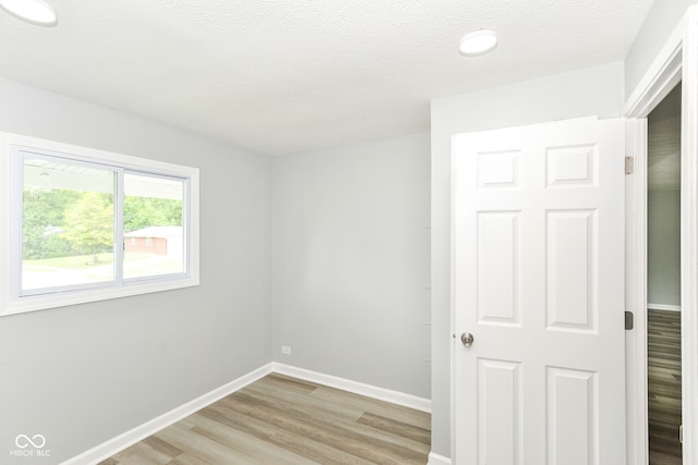 2521 Winfield Ave, Indianapolis, IN 46222 - empty room featuring light wood-style flooring and a textured ceiling
