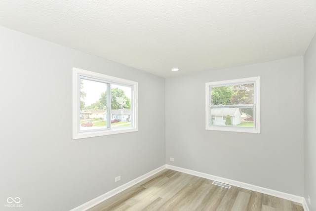 2521 Winfield Ave, Indianapolis, IN 46222 - empty room with light wood finished floors, healthy amount of natural light, and recessed lighting