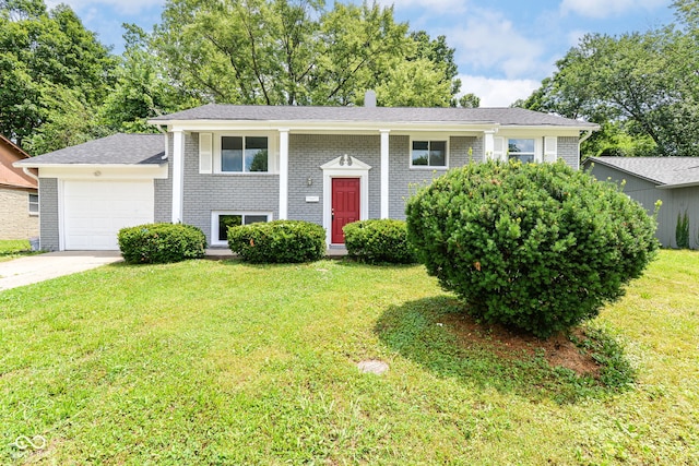 2521 Winfield Ave, Indianapolis, IN 46222 - bi-level home with an attached garage, brick siding, a front yard, and driveway