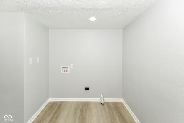 2521 Winfield Ave, Indianapolis, IN 46222 - washroom featuring washer hookup, light wood-type flooring, electric dryer hookup, and a textured ceiling