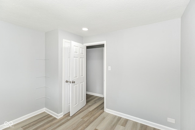 2521 Winfield Ave, Indianapolis, IN 46222 - empty room featuring light wood-style floors, a textured ceiling, and recessed lighting