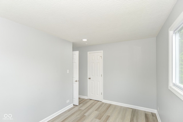 2521 Winfield Ave, Indianapolis, IN 46222 - empty room featuring light wood-style floors, recessed lighting, and a textured ceiling