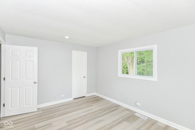 2521 Winfield Ave, Indianapolis, IN 46222 - unfurnished bedroom with light wood-type flooring, recessed lighting, and a closet