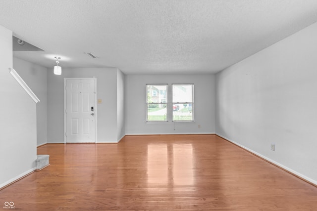12443 Rose Haven Dr, Indianapolis, IN 46235 - unfurnished living room with wood finished floors and a textured ceiling