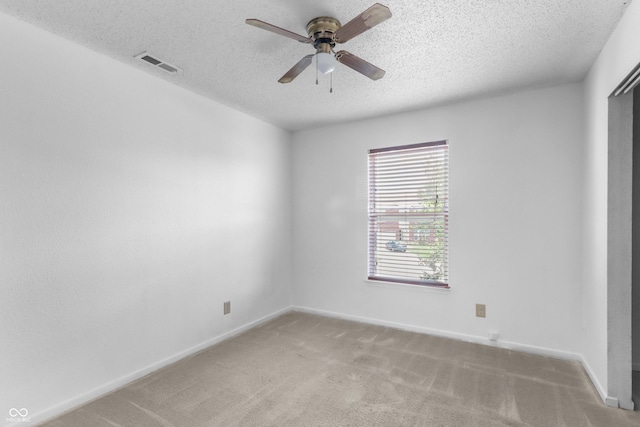 12443 Rose Haven Dr, Indianapolis, IN 46235 - spare room featuring a textured ceiling, ceiling fan, and light carpet