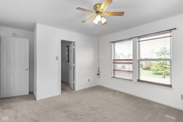 12443 Rose Haven Dr, Indianapolis, IN 46235 - unfurnished bedroom with light colored carpet, a textured ceiling, a spacious closet, and a ceiling fan