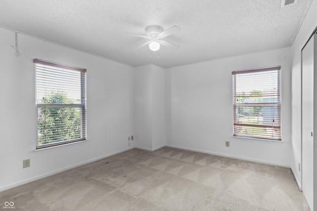 12443 Rose Haven Dr, Indianapolis, IN 46235 - spare room with light carpet, ceiling fan, healthy amount of natural light, and a textured ceiling