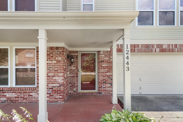 12443 Rose Haven Dr, Indianapolis, IN 46235 - entrance to property featuring brick siding, a garage, and a porch